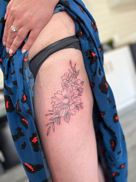 Beautiful floral hip tattoo, stunning floral piece with shaded leaves