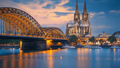The-Cologne-Cathedral-and-Hohenzollern-bridge-across-the-Rhine-river-in-Germany.webp