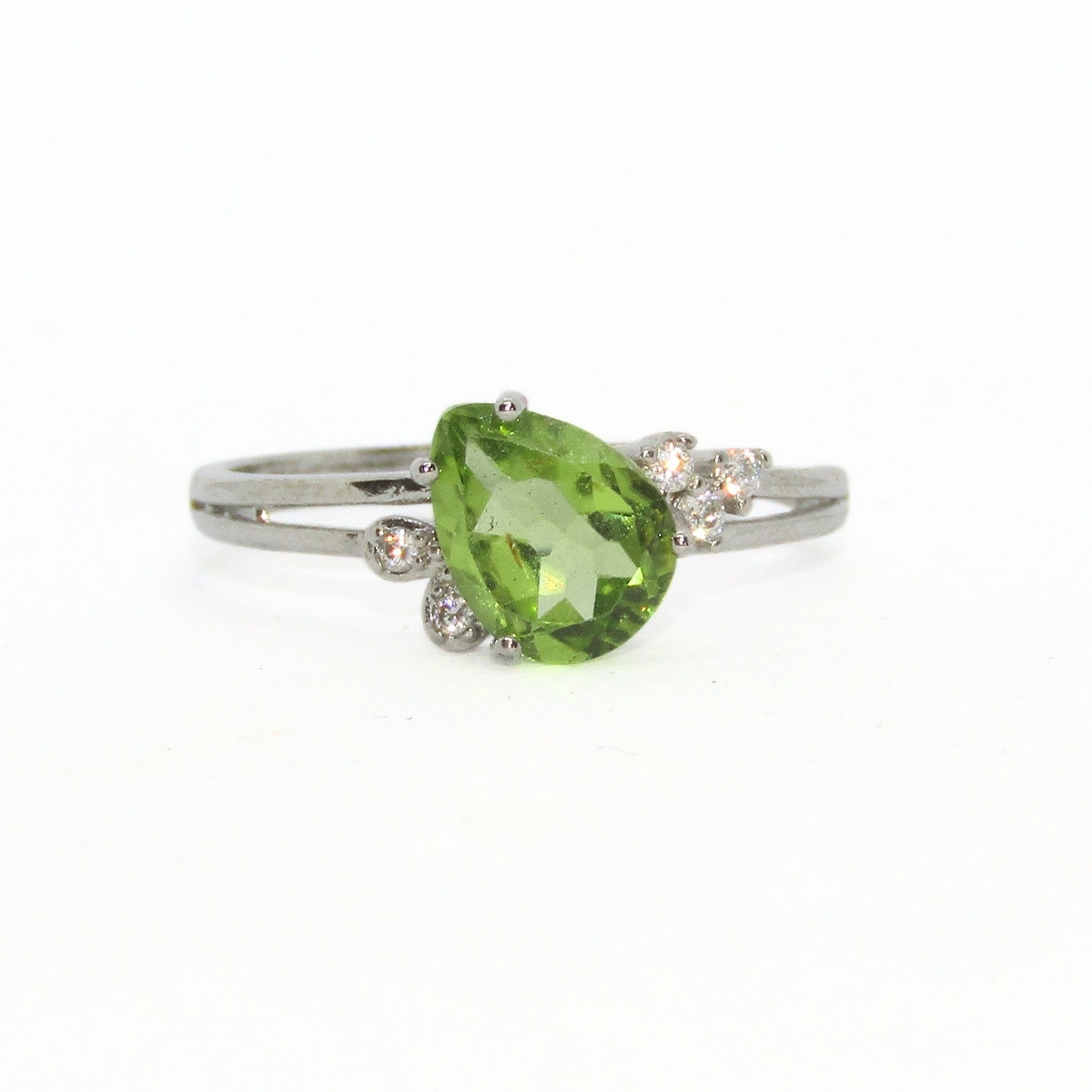 Elegant sterling silver peridot ring with pear-shaped peridot stone and zircon accents.