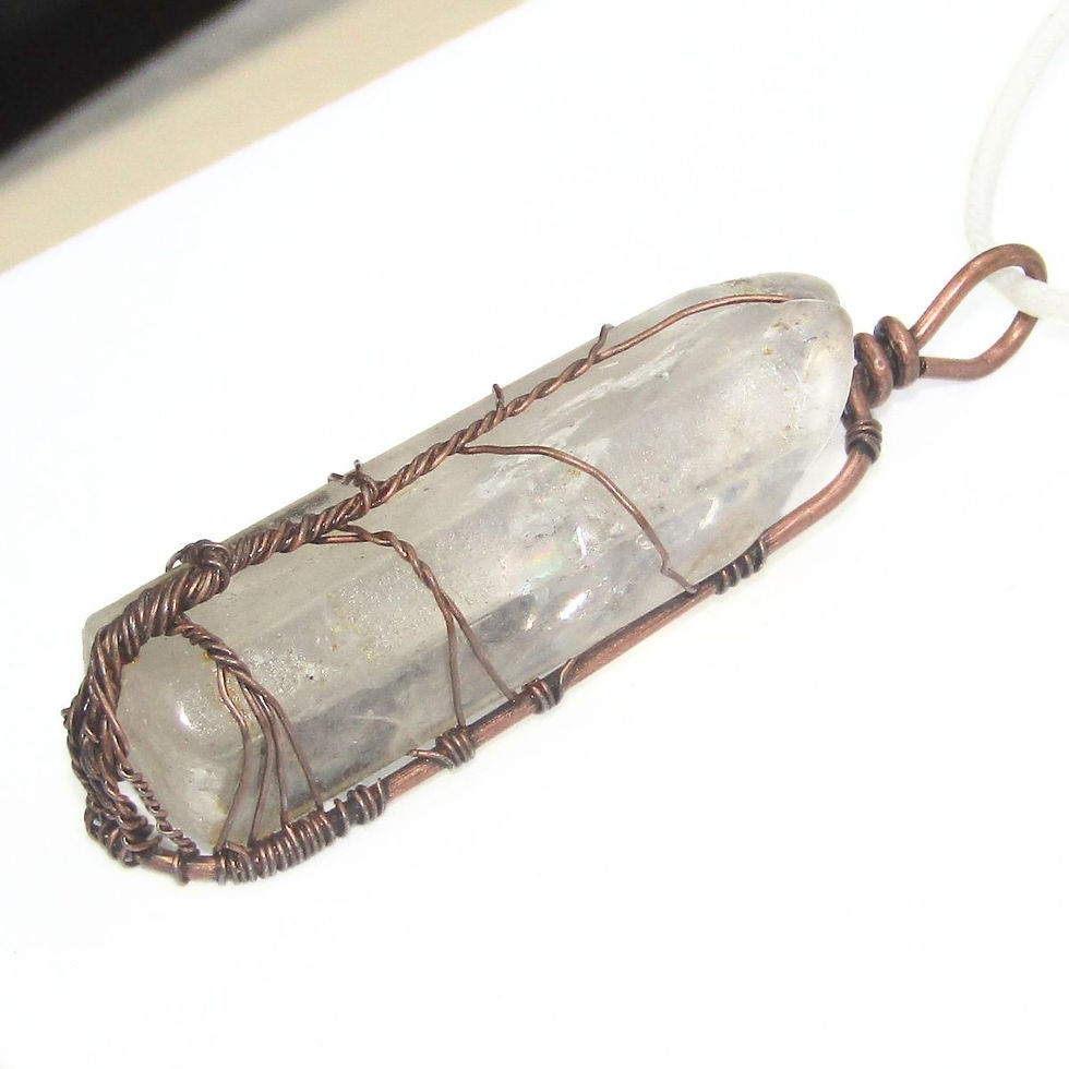 Thumbnail: Clear quartz tree of life pendant styled on a display surface.