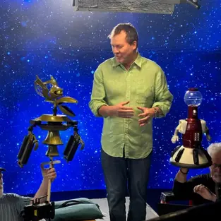 Mike Nelson, Kevin Murphy, and Bill Corbett from RiffTrax announcing Mystery Science Theater 3000: The RiffTrax Experiments Kickstarter campaign featuring the Satellite of Love and robot silhouettes