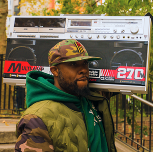 Man carrying the Bumpboxx BB 777 retro boombox outdoors, 270W portable stereo with cassette and Bluetooth