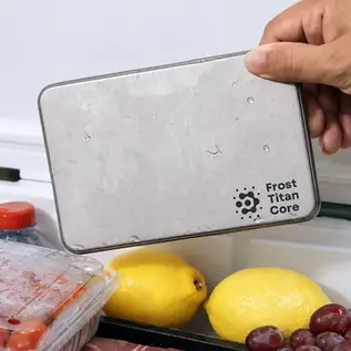 Frost Titan Core Plate, a flat titanium cooling plate with a dark rim, covered in condensation on a wooden slatted table