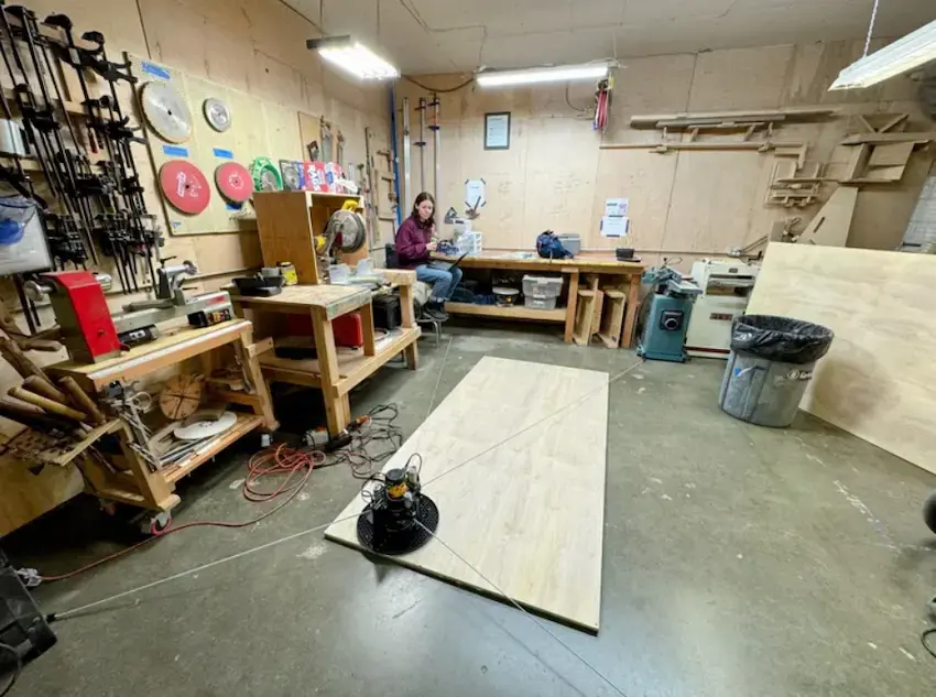 Maslow 4.1 CNC router sled anchored to a workshop concrete floor cutting a full 4x8 foot plywood sheet