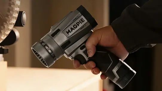 Magpie Air Cannon GPX blower in hand, demonstrating the small one-handed form factor of the cordless Kickstarter blower.