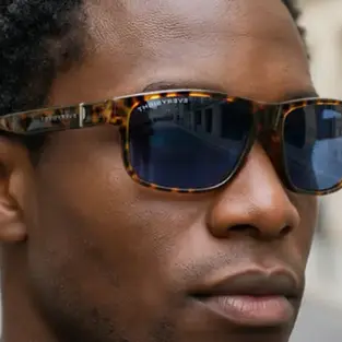 Man wearing Maverick AI glasses on Kickstarter outdoors, lightweight AR smart glasses by Everysight with OLED display and AI camera