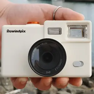 Hand holding the Rewindpix Camera on Kickstarter, retro digital film camera with mechanical winder and optical viewfinder