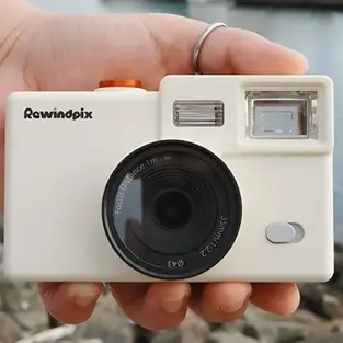 Hand holding the Rewindpix Camera on Kickstarter, retro digital film camera with mechanical winder and optical viewfinder