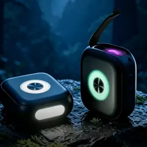Compact black WAIORD K7 EDC multi-tool displayed on a moss-covered rock at night, with its circular green light glowing and purple plasma arc igniter visible.