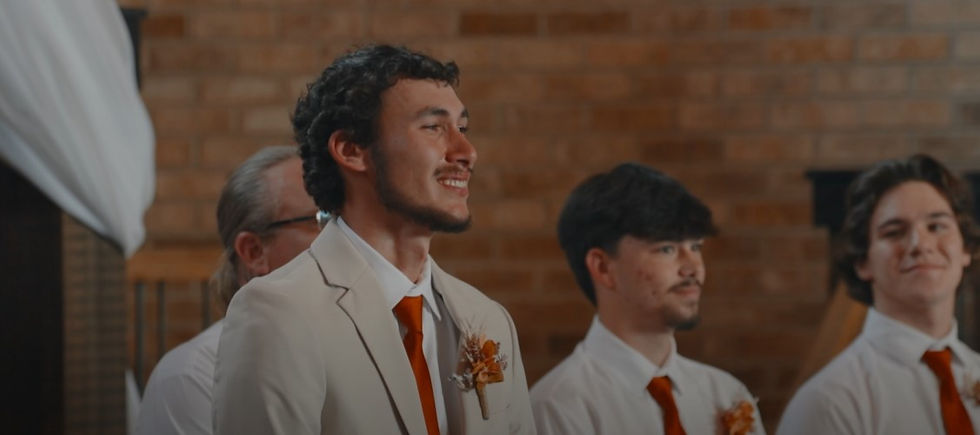 groom's first look of bride walking down the aisle