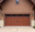 Attached garage with a garage door with a plank wood appearance.jpg