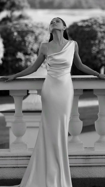 Dua by Olya Mak bridal gown with one off the shoulder and a sleek fit
