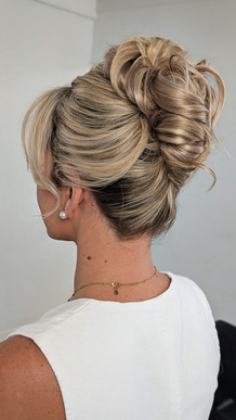 Bride with tousled high bun french twist updo by st augustine hairstylist