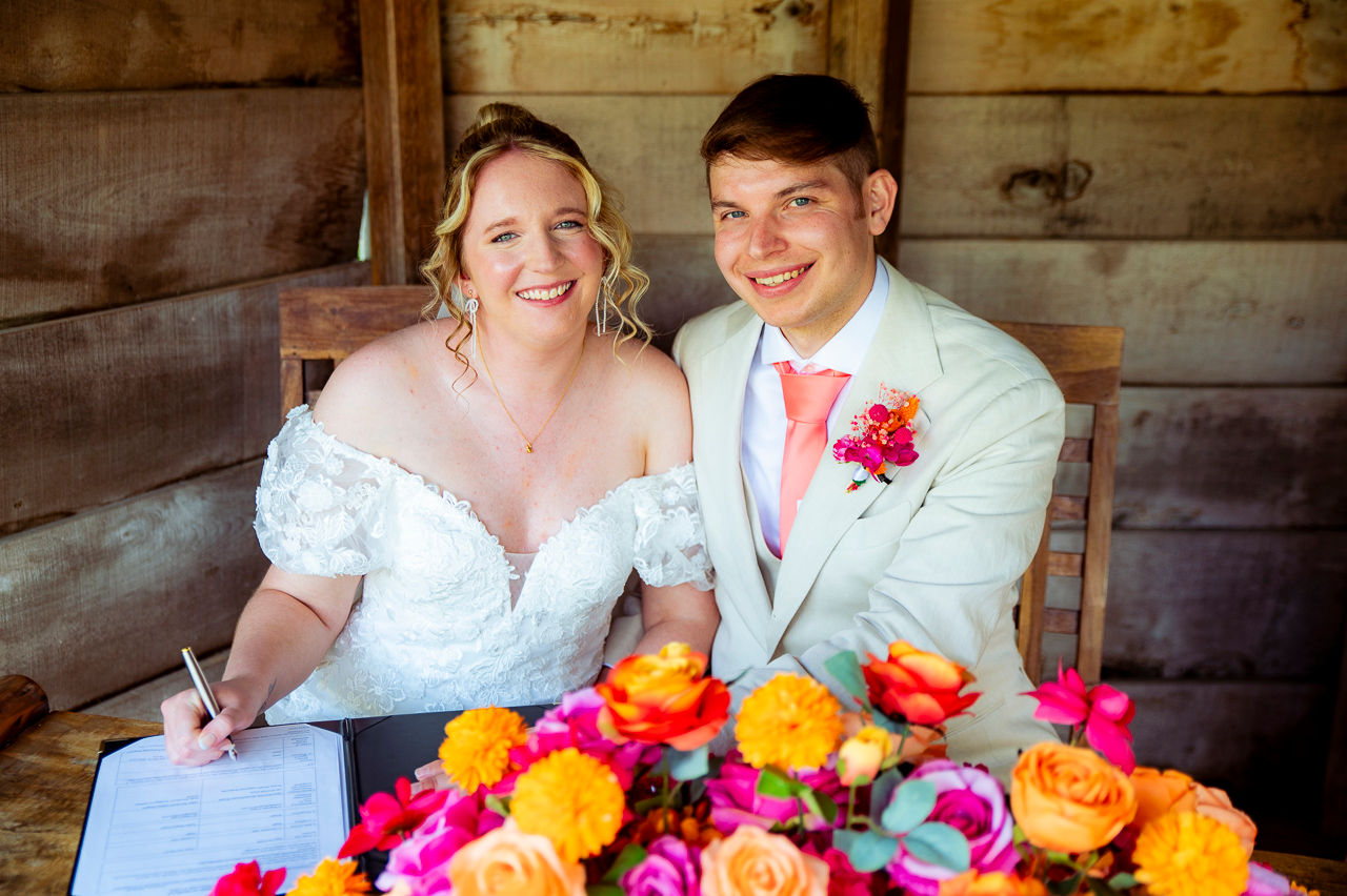 a newly married couple smiling at the camera