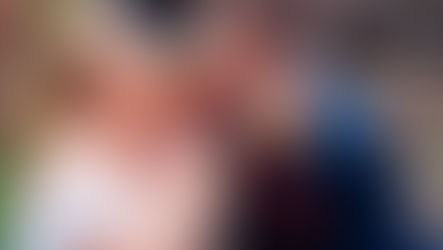 a bride and groom sharing a sausage roll