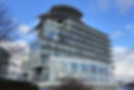 Eye-level view of St David’s Hotel overlooking Cardiff Bay with calm water and clear sky