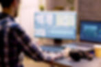 A laptop and monitor displaying a large video marketing editing project