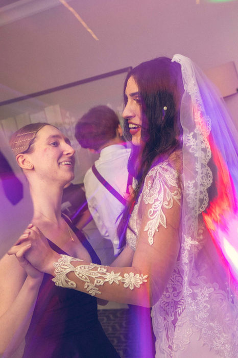 Guests cheering during a wedding reception celebration