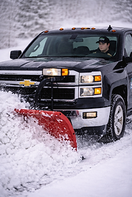 Snowplow driver clears snowy roadways.png