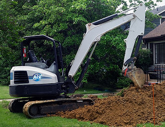 Excavator digging sewer and water in front yard.