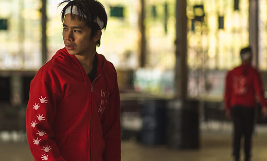 Man wearing red looks over his shoulder