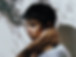 Dark haired man with shadow of trees