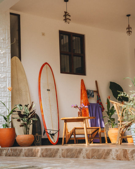 outside area with surfboards standing on a wall at the house