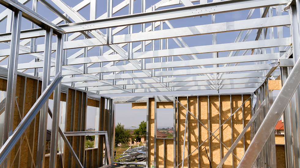 Steel‑framed building with exterior sheathing installed on jobsite.