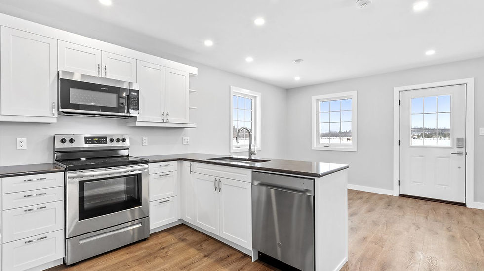Humble Creek Construction bright white shaker ADU kitchen renovation with dark countertops and window view Ottawa