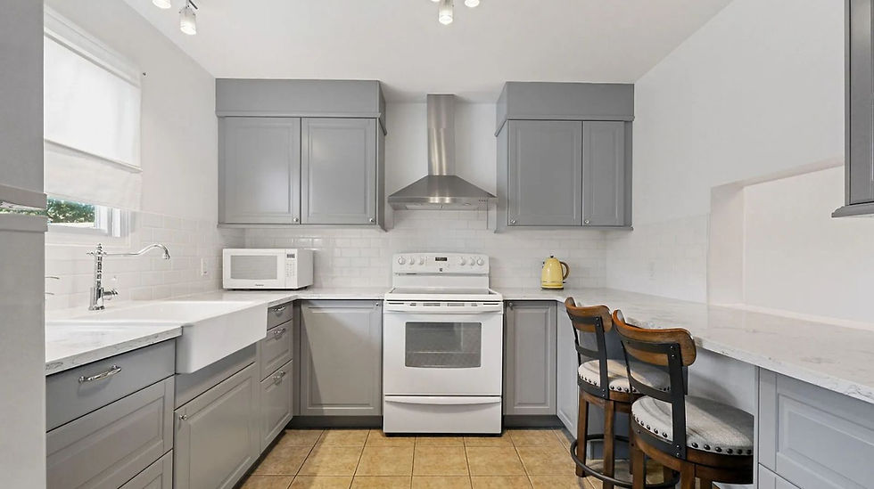 Humble Creek Construction bright transitional kitchen renovation with light grey shaker cabinets white subway tile backsplash and porcelain farmhouse sink Ottawa