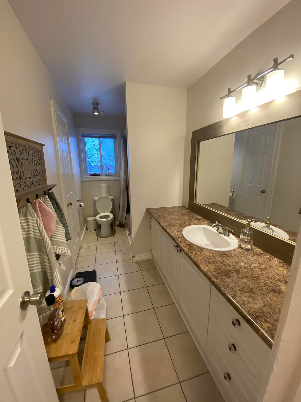 Before Modern bathroom renovation with custom vanity and fixtures.