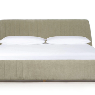 Sage green upholstered bed with vertical channel tufting