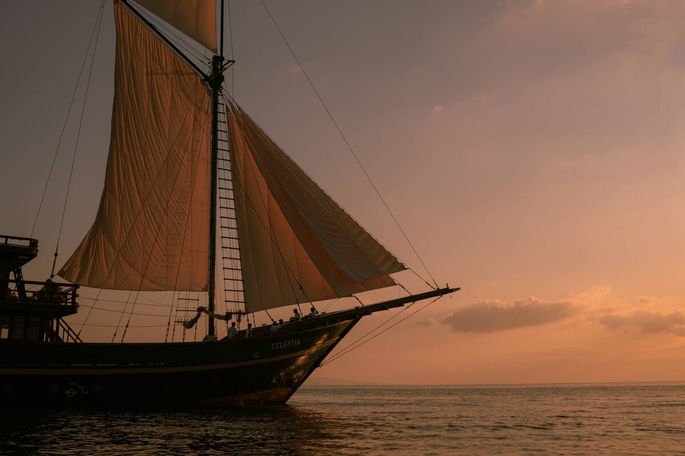 48m two-masted Phinisi yacht showcasing traditional Indonesian craftsmanship and classic wooden sailing silhouette on open water
