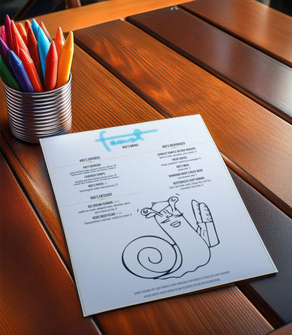 Kid's menu at Feast, a French restaurant, featuring a coloring page of a snail holding a baguette