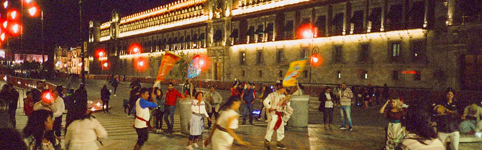 Zócalo photography filming of night event at National Palace. Dancers in traditional outfits perform their rituals.