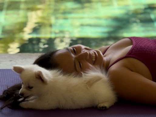 Girl cuddling a rescue puppy at a yoga class in Bali