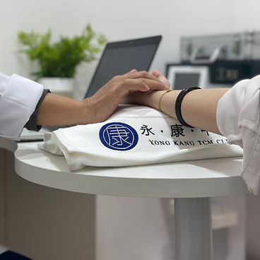 Doctor checking patient's pulse with Yong Kang TCM Center logo LP -tcm tech