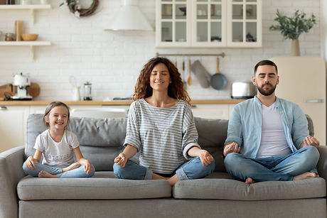 Calm young family meditating.