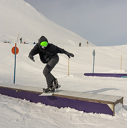 Snow park box tricks Snowboarder in the park on a box Winter jibbing in snwopark in France