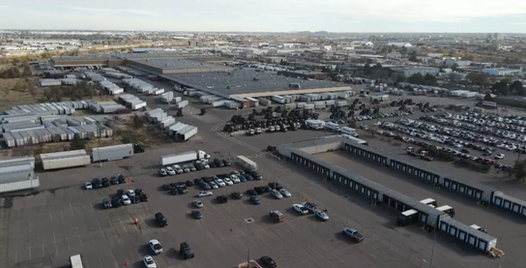 Aerial photograph of a UPS automated distribution campus with loading docks, trailer storage, and vehicle circulation.