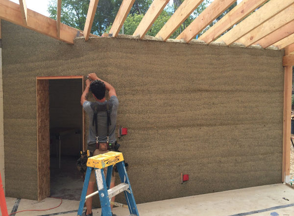 A construction working on interior of sustainable building