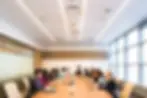 Some people are sitting in office meeting room