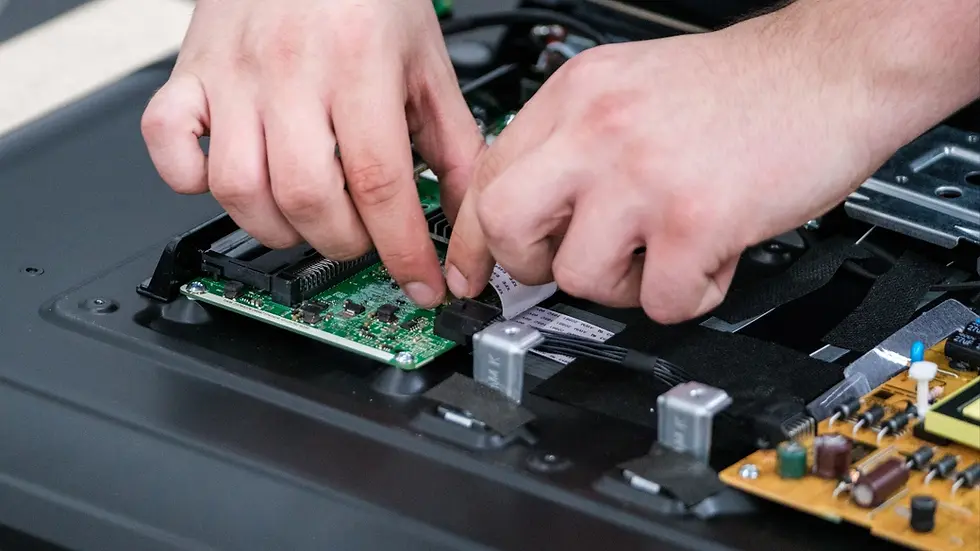 Technician connecting internal cables during box build assembly