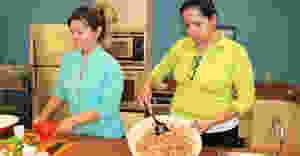 2 female facilitators cooking on a counter