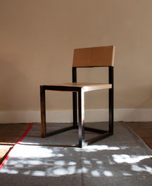 a chair is sitting on a rug in front of a wall