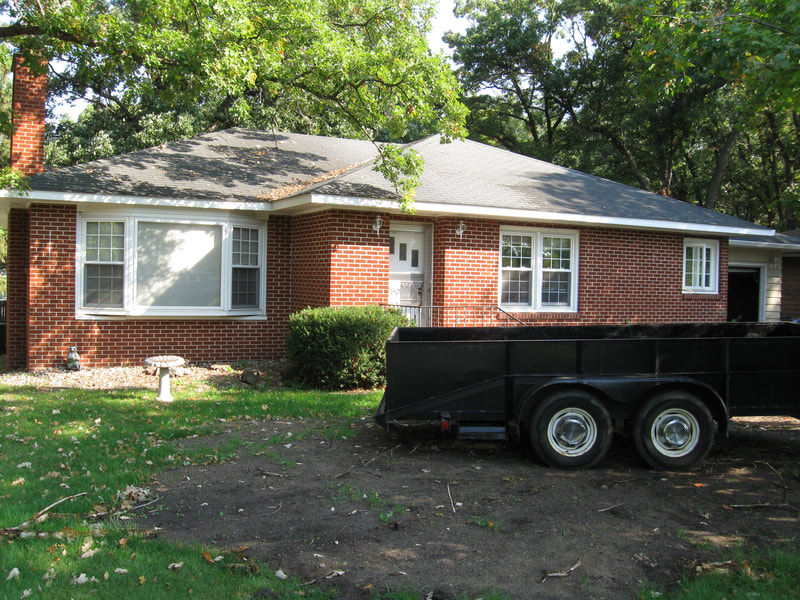 Single family red brick rambler with hip roof.