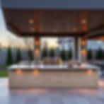 A luxury outdoor kitchen island with a large stainless steel built-in grill, natural stone countertops, warm evening light, luxury modern architectural outdoor entertaining space, no people, editorial photography