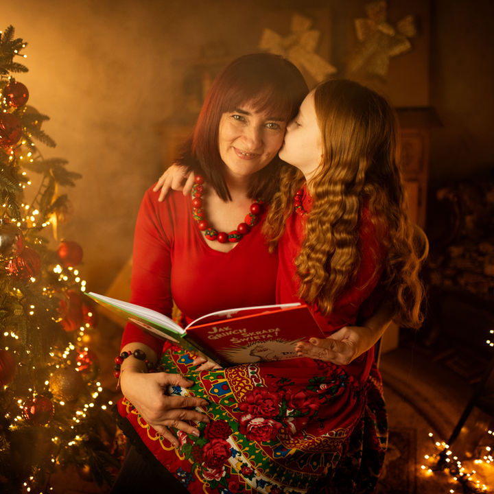 Daughter kissing her mother during a Christmas photoshoot