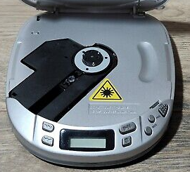 portable cd player with cover opened showing the optical lens cd reader