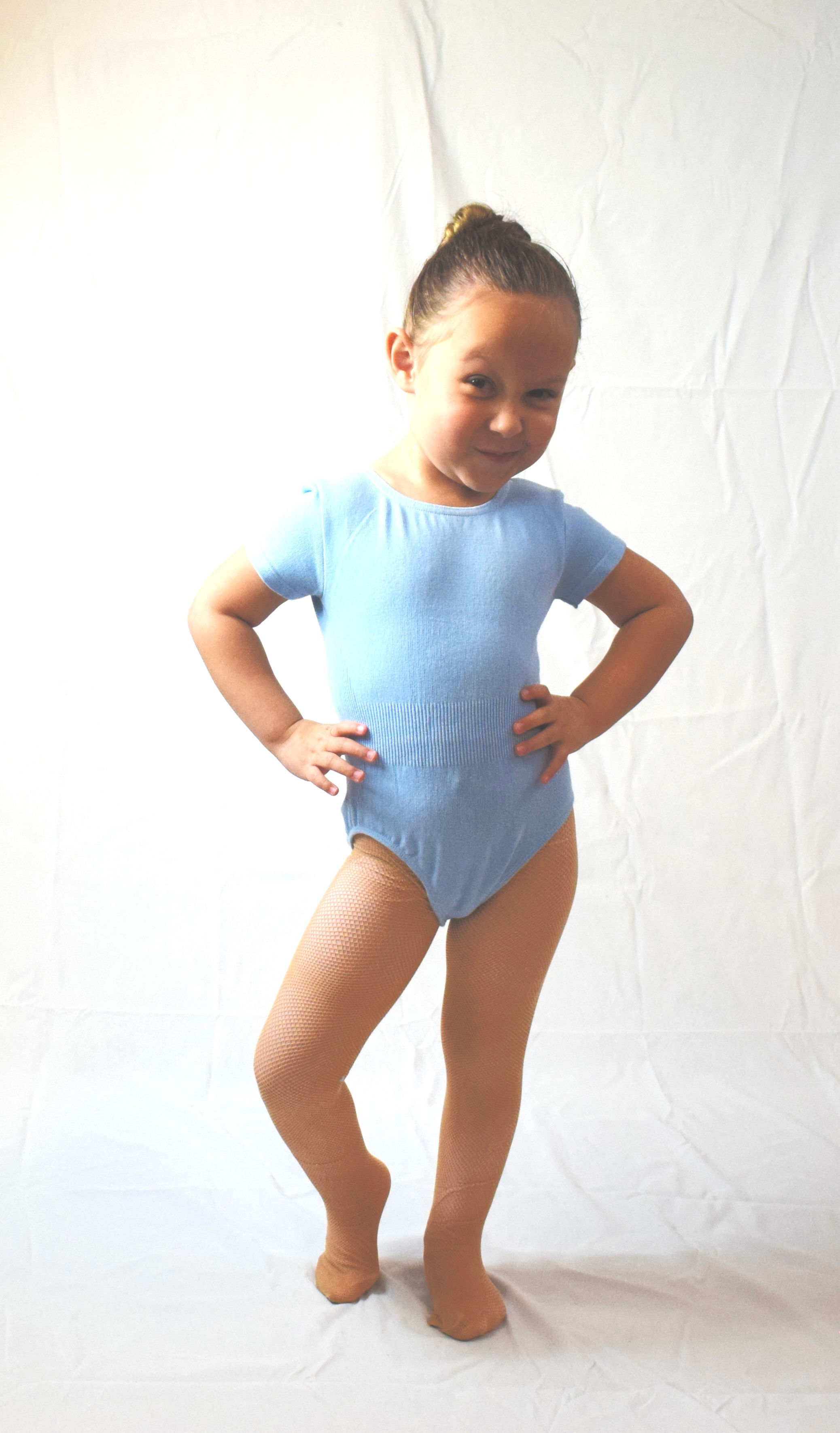 girl wearing blue leotard and fishnet tights